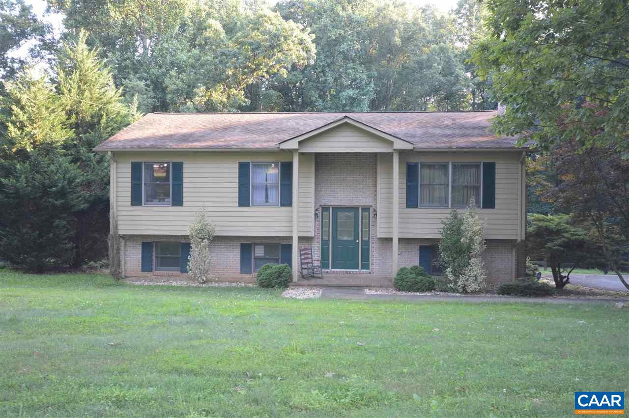389 Morning Glory Road Ruckersville, VA 22968 - Photo 2 of 34 a front view of a house with a garden