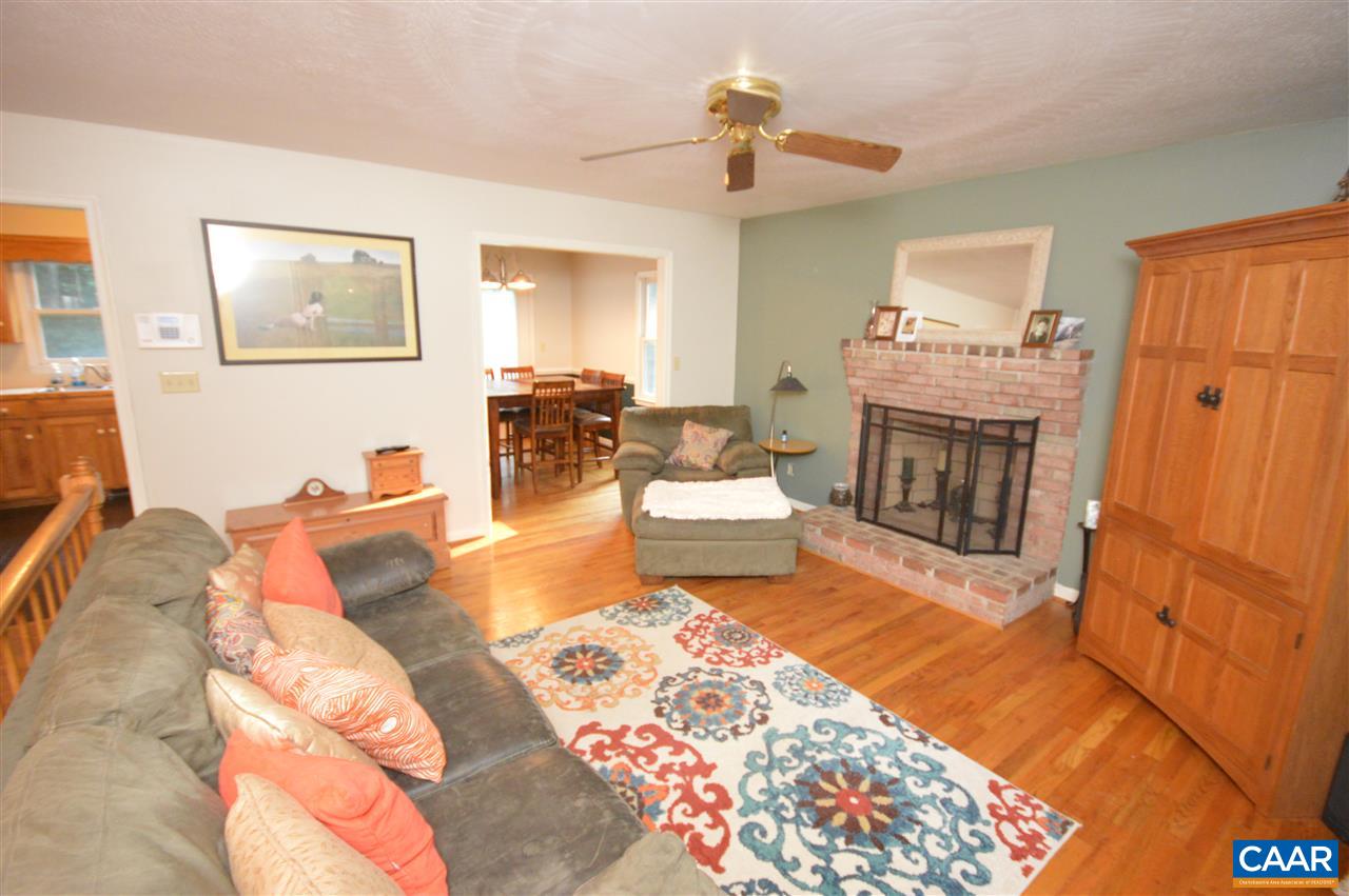 389 Morning Glory Road Ruckersville, VA 22968 - Photo 23 of 34 a living room with furniture and a fireplace
