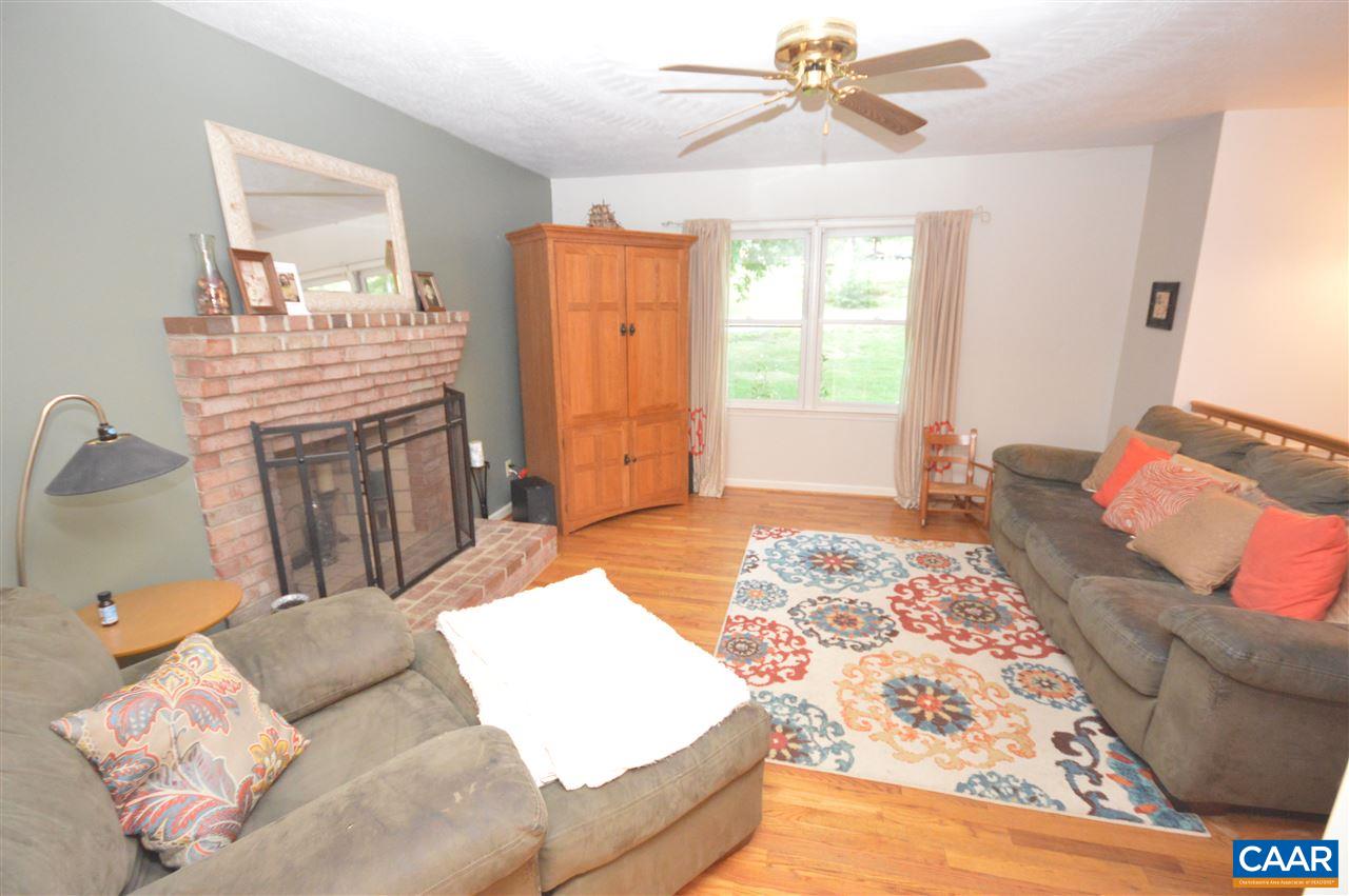 389 Morning Glory Road Ruckersville, VA 22968 - Photo 24 of 34 a bedroom with a bed and wooden floor