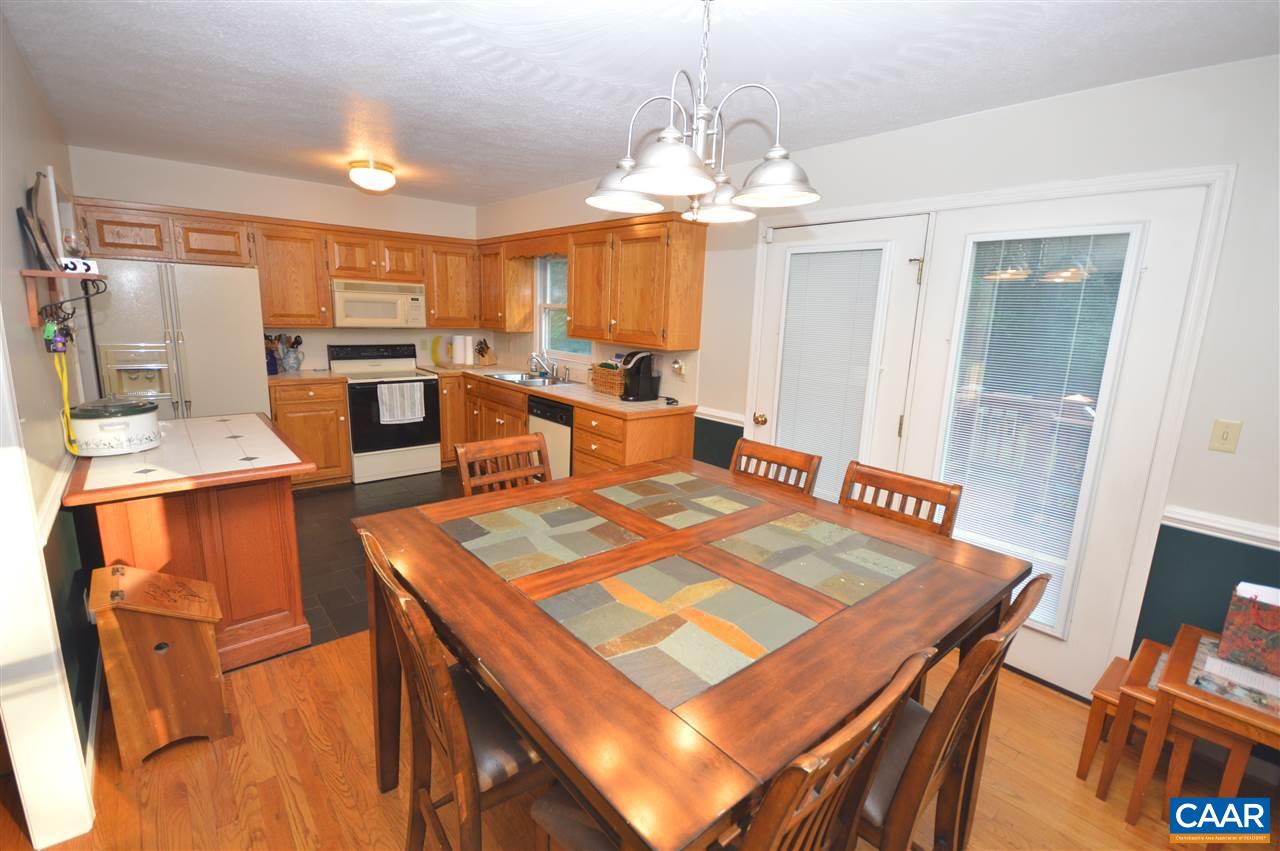 389 Morning Glory Road Ruckersville, VA 22968 - Photo 25 of 34 a view of a dining room with furniture and a chandelier