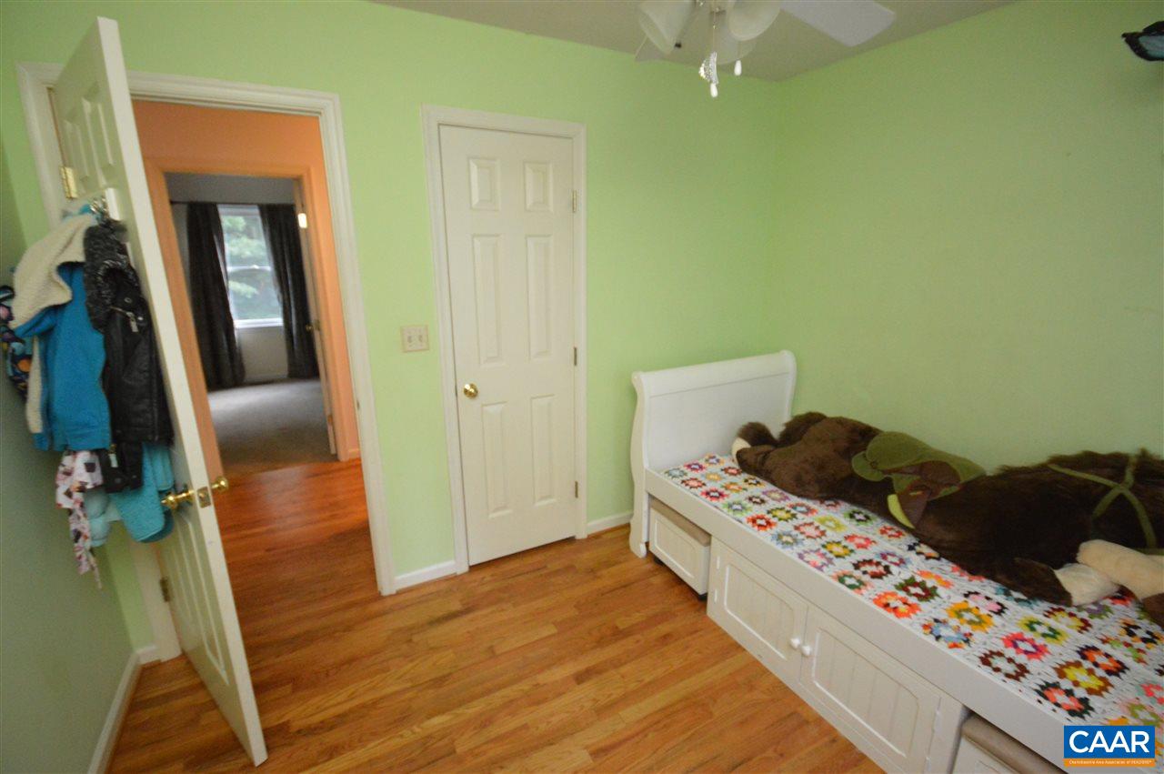 389 Morning Glory Road Ruckersville, VA 22968 - Photo 31 of 34 a bedroom with a bed and wooden floor