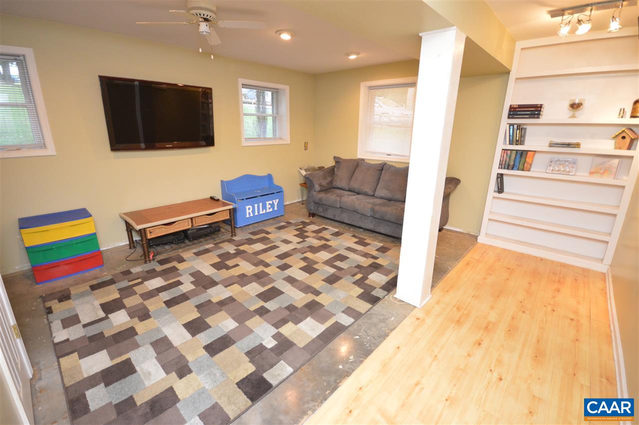 389 Morning Glory Road Ruckersville, VA 22968 - Photo 34 of 34 a living room with furniture and a flat screen tv