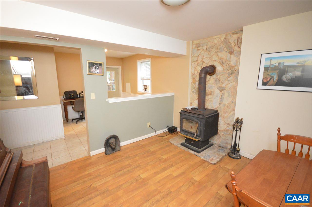389 Morning Glory Road Ruckersville, VA 22968 - Photo 7 of 34 a bedroom with a bed and a chair with the bookshelf