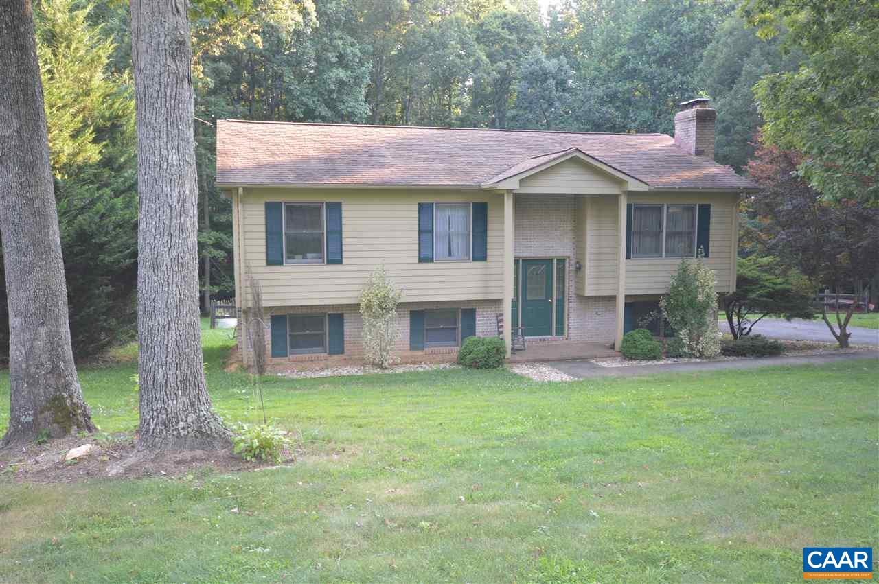 389 Morning Glory Road Ruckersville, VA 22968 - Photo 9 of 34 a front view of a house with a yard and garage