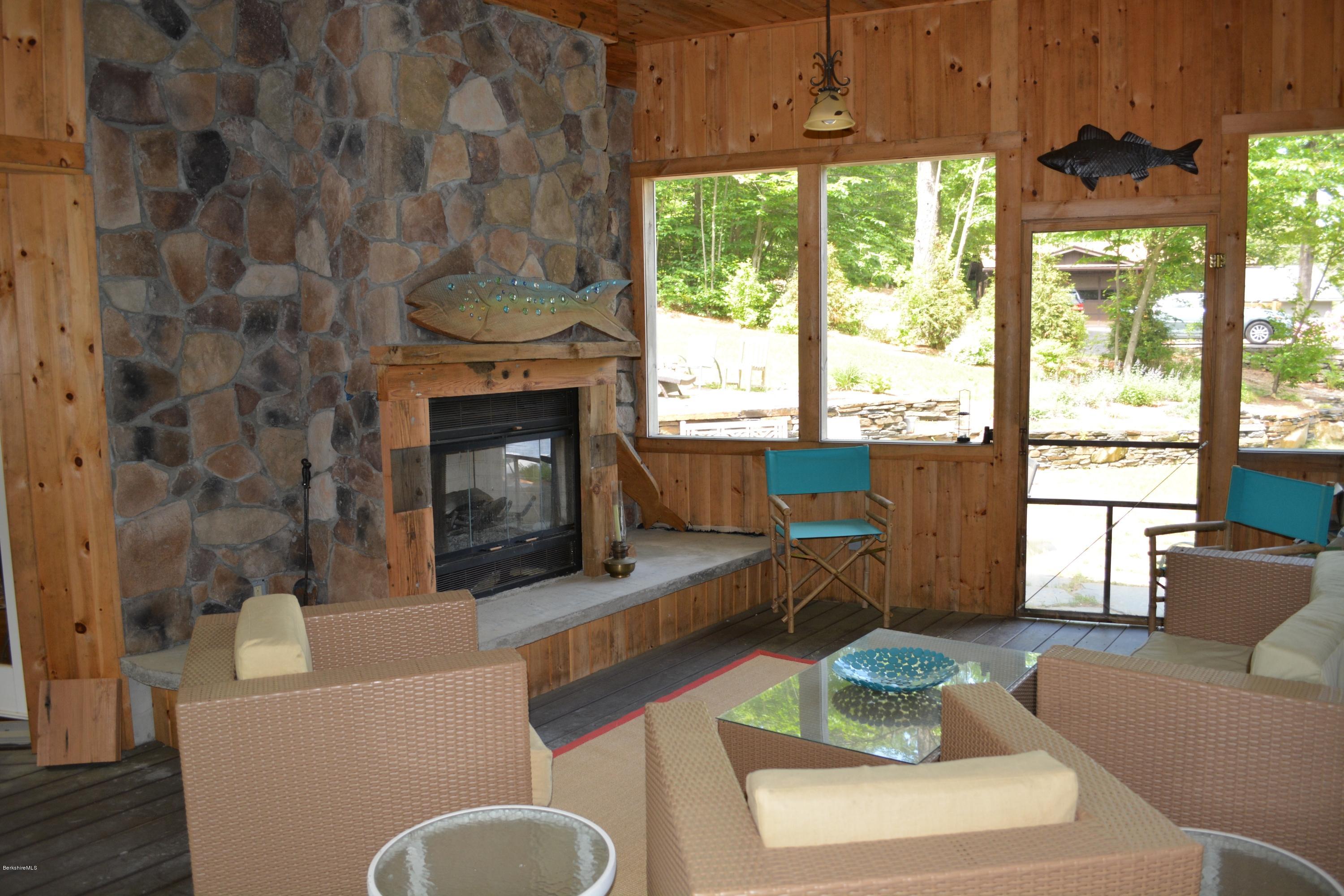 317 Pine Road Otis, MA 01029 - Photo 11 of 27 a living room with furniture a fireplace and a large window