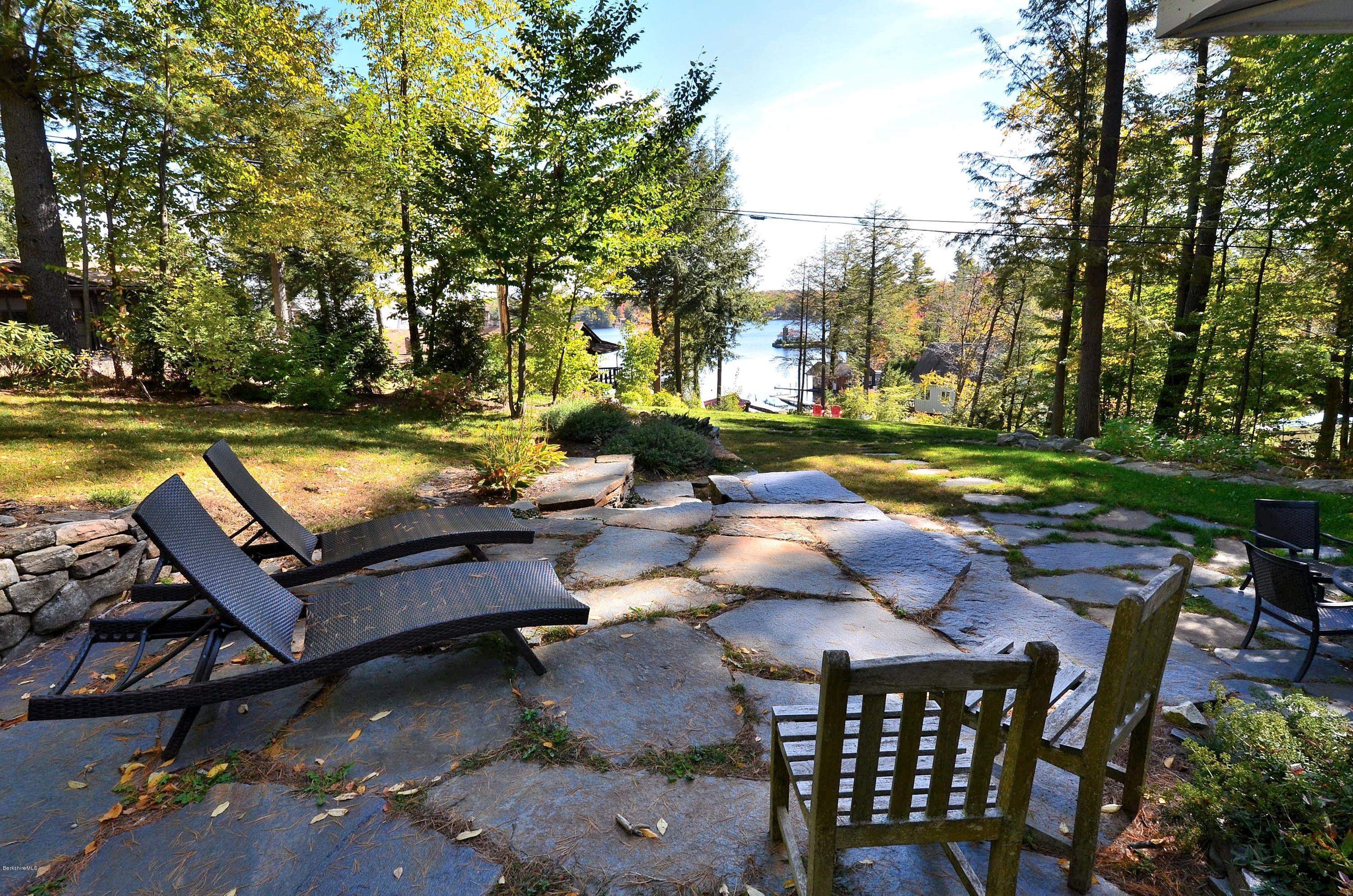 317 Pine Road Otis, MA 01029 - Photo 23 of 27 a view of a patio with swimming pool and chairs