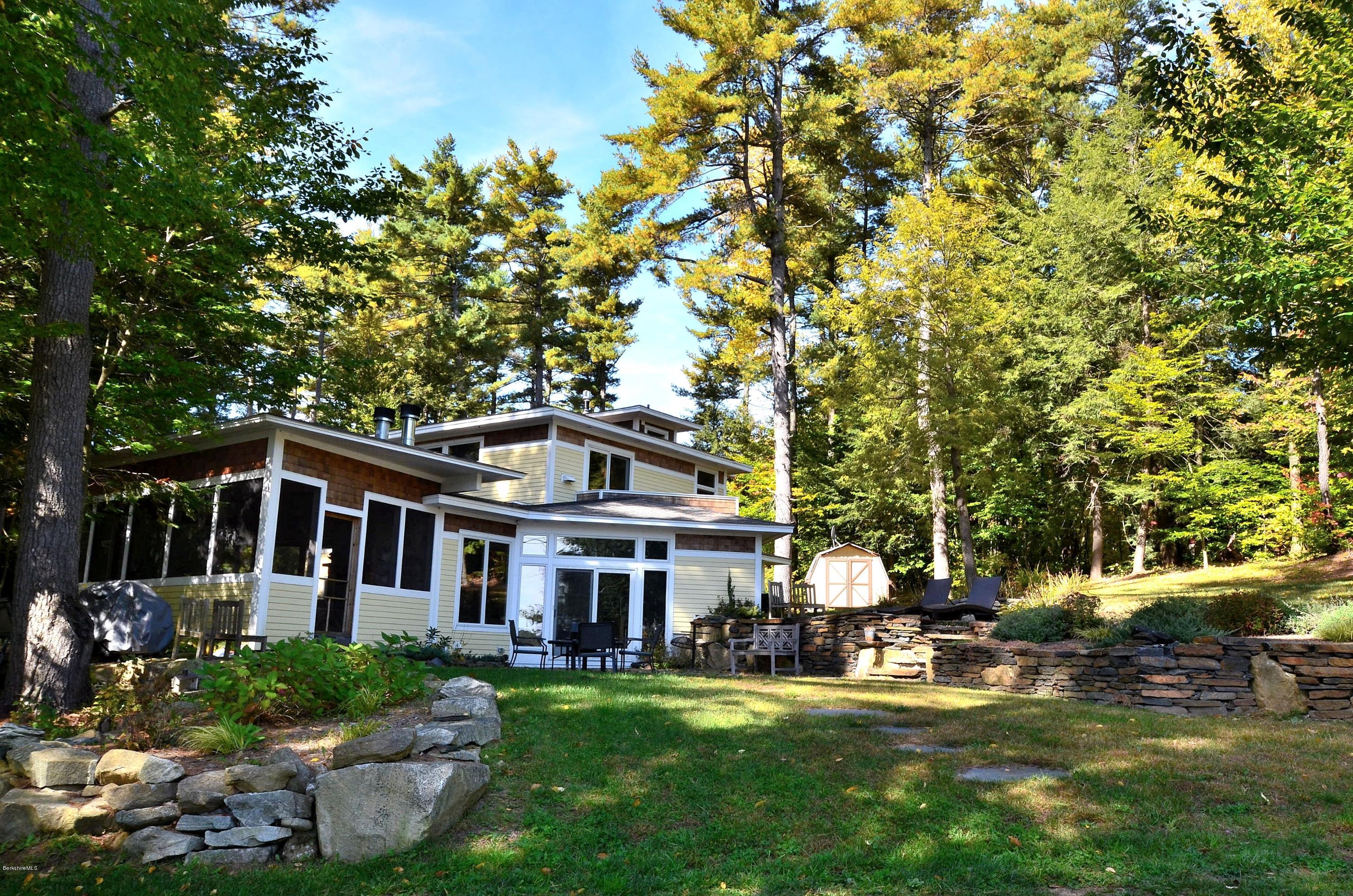 317 Pine Road Otis, MA 01029 - Photo 24 of 27 a front view of a house with swimming pool and sitting area