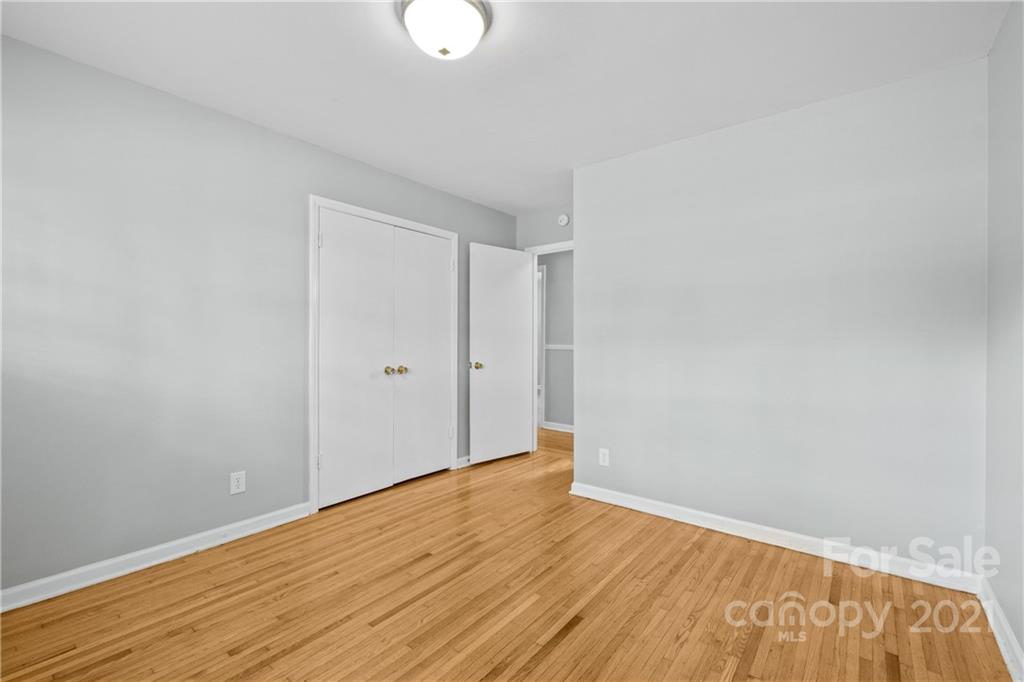 6833 Idlewild Road Charlotte, NC 28212 - Photo 16 of 24 a view of an empty room with wooden floor