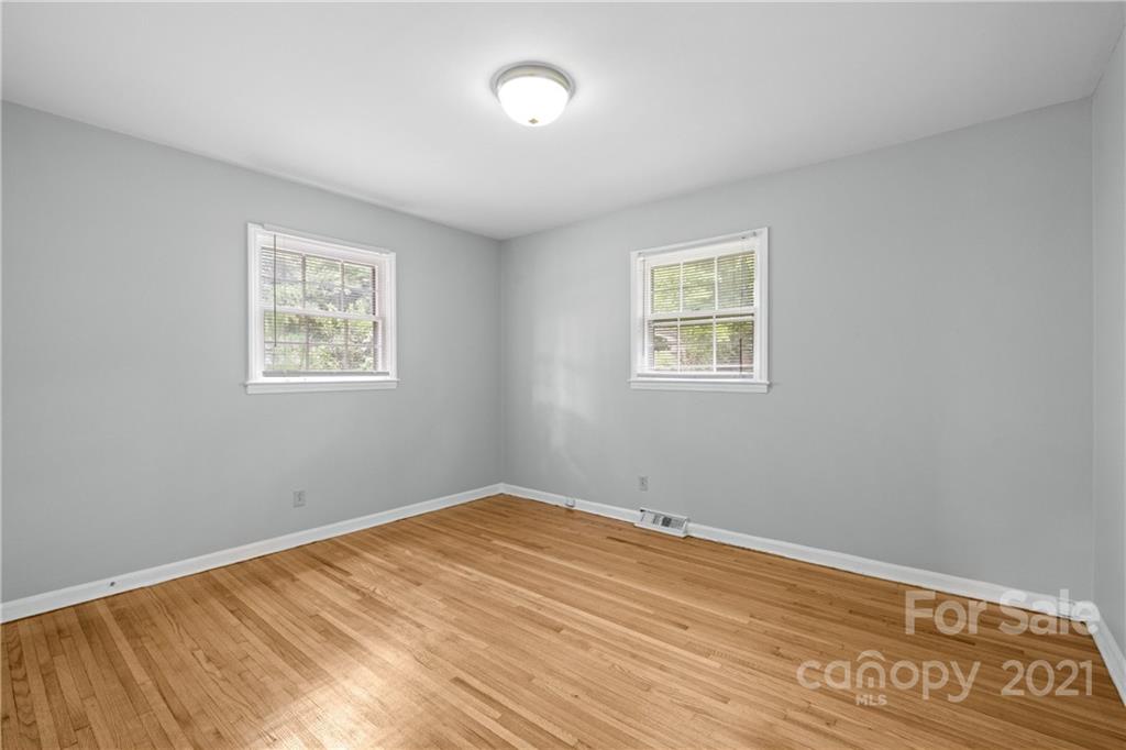 6833 Idlewild Road Charlotte, NC 28212 - Photo 17 of 24 a view of a room with wooden floor and windows