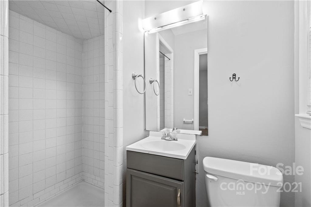 6833 Idlewild Road Charlotte, NC 28212 - Photo 20 of 24 a bathroom with a sink toilet and mirror