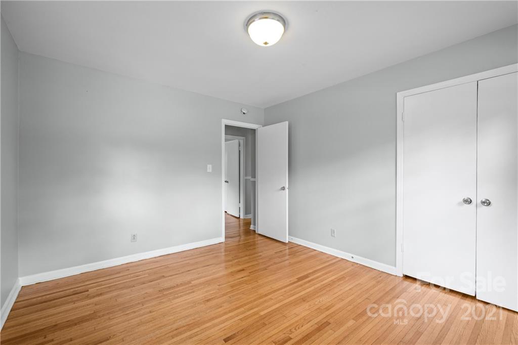 6833 Idlewild Road Charlotte, NC 28212 - Photo 22 of 24 a view of an empty room with wooden floor and a window