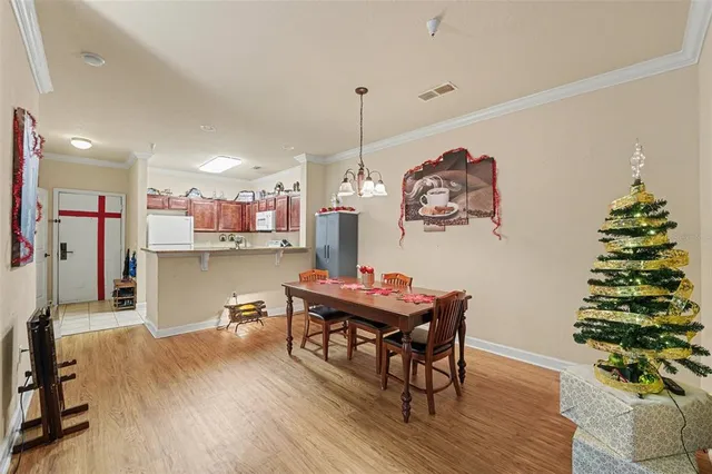 a view of a dining room with furniture and chandelier