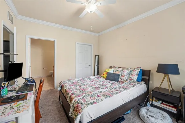 a bathroom with a granite countertop toilet sink and mirror