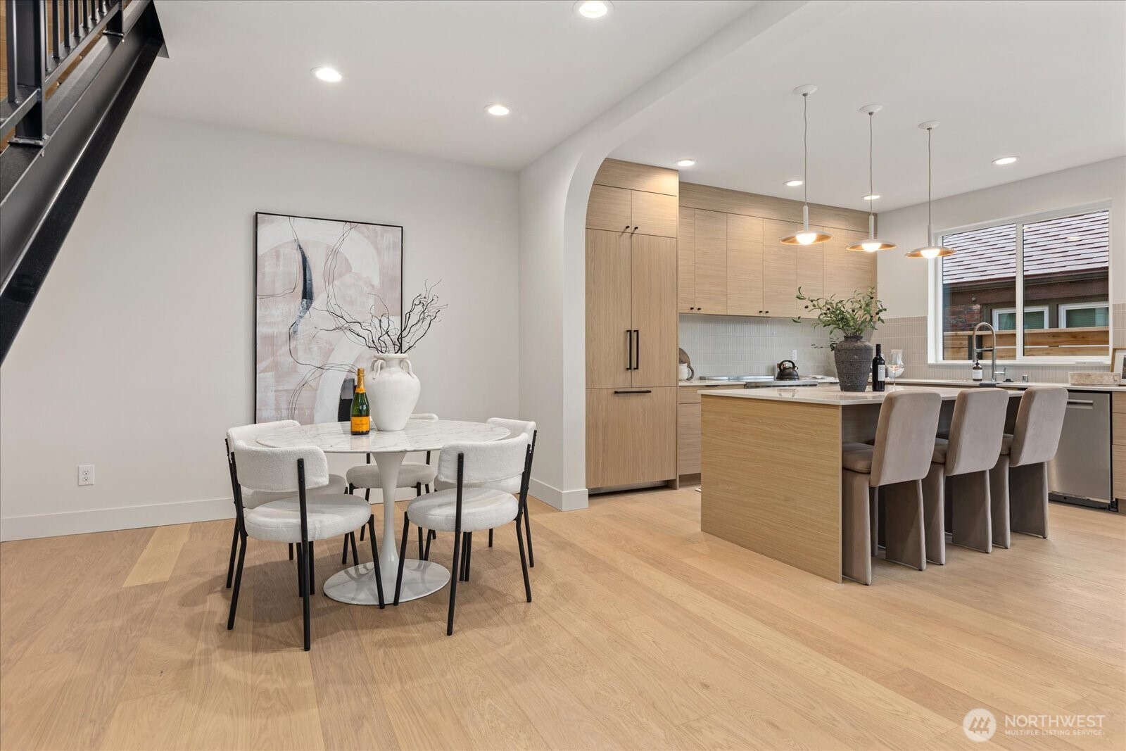 3409 Northwest 57th Street Seattle, WA 98107 - Photo 14 of 39 a dining room with kitchen island a table and chairs in it