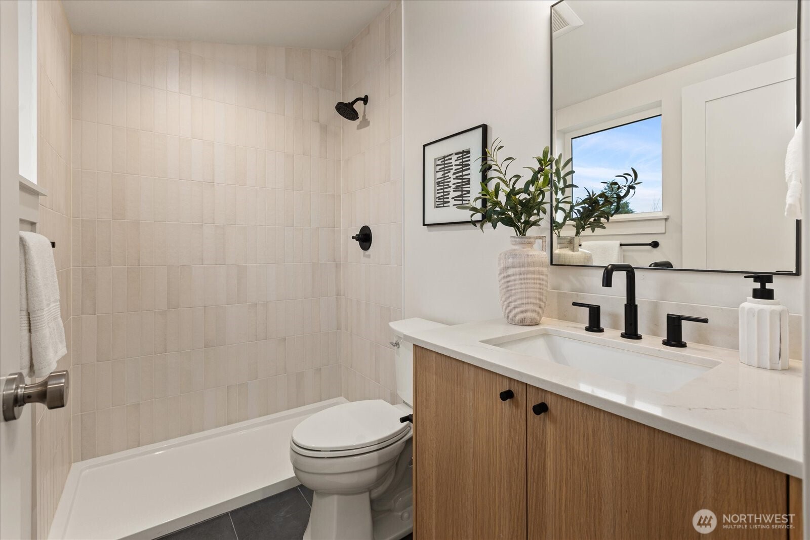 3409 Northwest 57th Street Seattle, WA 98107 - Photo 29 of 39 a bathroom with a sink a toilet and shower