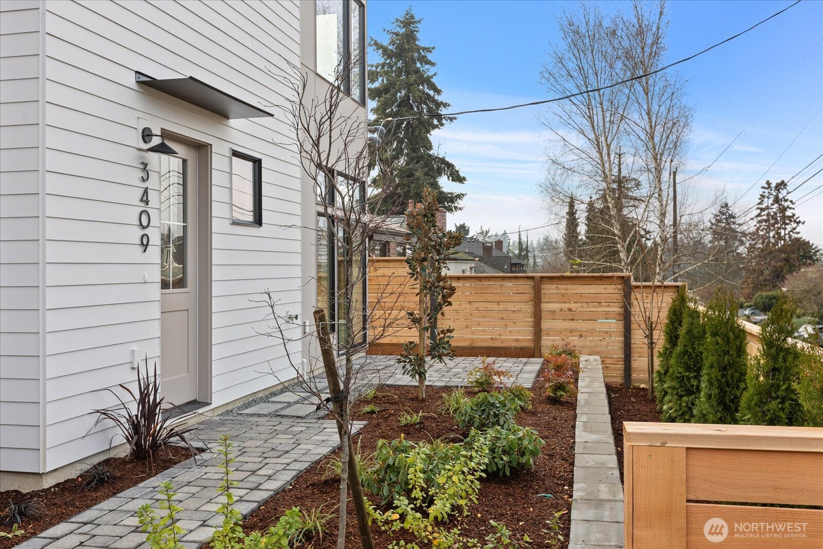 3409 Northwest 57th Street Seattle, WA 98107 - Photo 4 of 39 a view of a yard with chairs and a tree