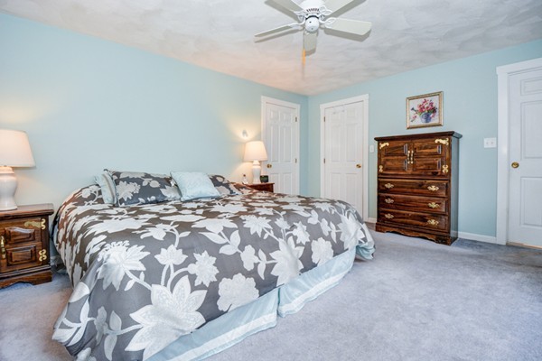 43 Robert Road Stow, MA 01775 - Photo 16 of 22 a bedroom with a bed and a chandelier