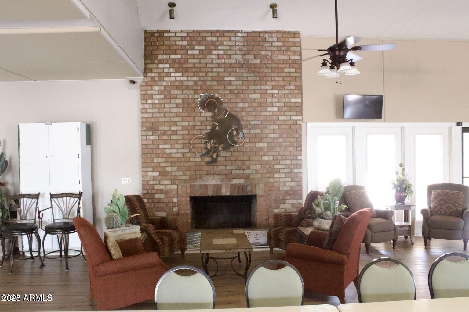 5735 East McDowell Road, Unit 63 Mesa, AZ 85215 - Photo 16 of 27 a living room with furniture windows and a fireplace