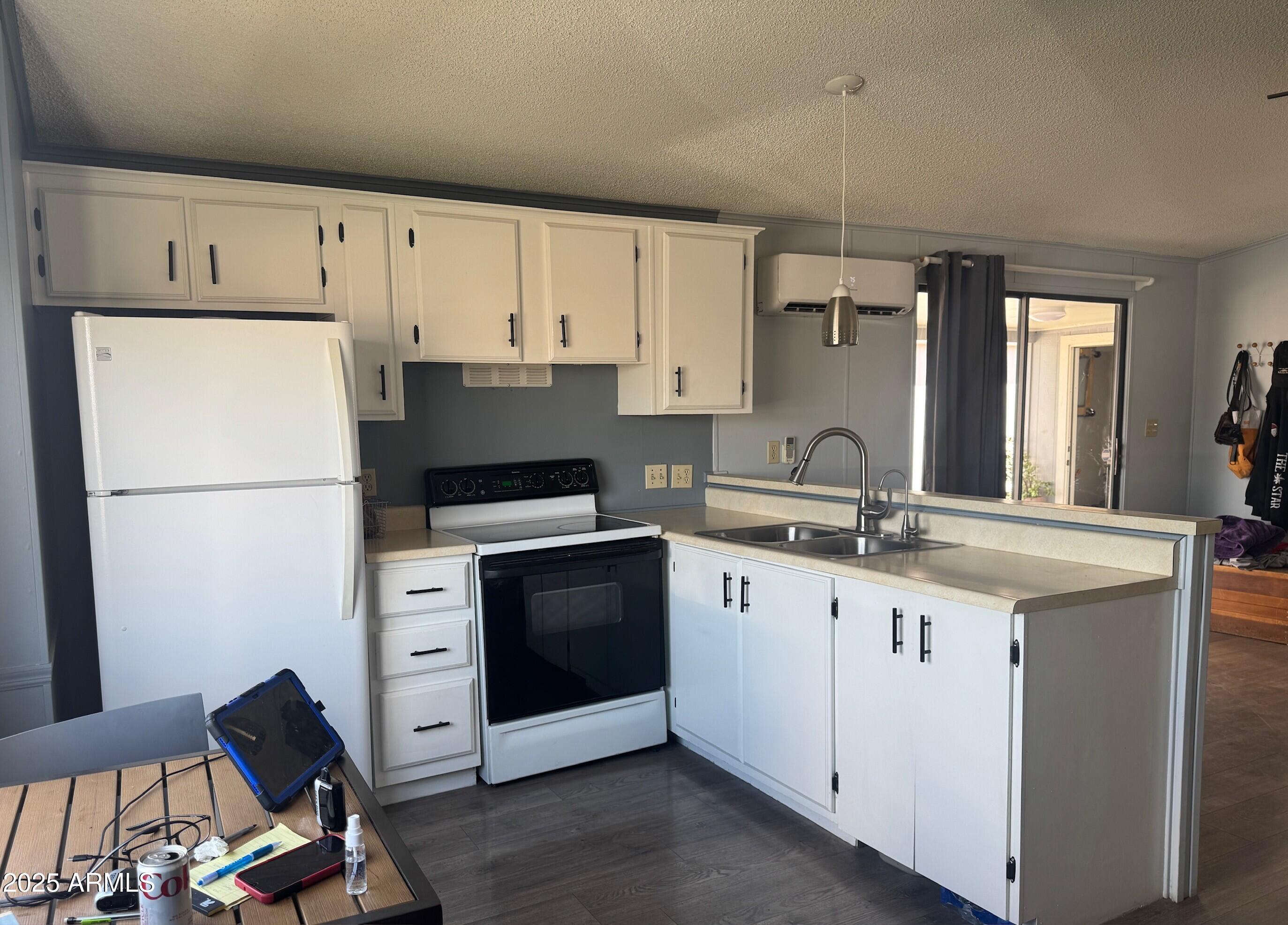 5735 East McDowell Road, Unit 63 Mesa, AZ 85215 - Photo 2 of 27 a kitchen with granite countertop a sink stove and refrigerator