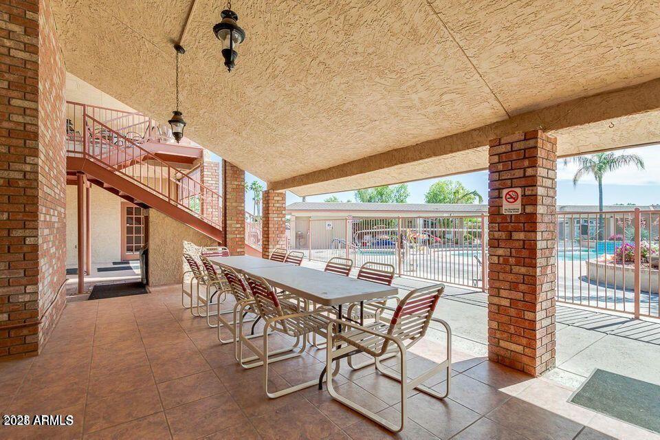 5735 East McDowell Road, Unit 63 Mesa, AZ 85215 - Photo 22 of 27 a view of a patio with table and chairs
