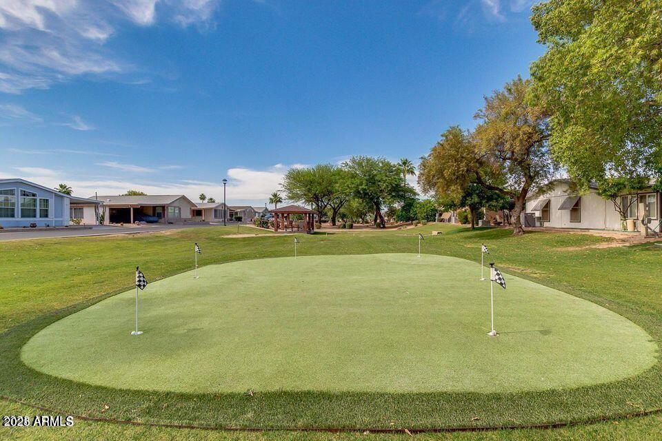 5735 East McDowell Road, Unit 63 Mesa, AZ 85215 - Photo 23 of 27 a swimming pool with outdoor seating and yard