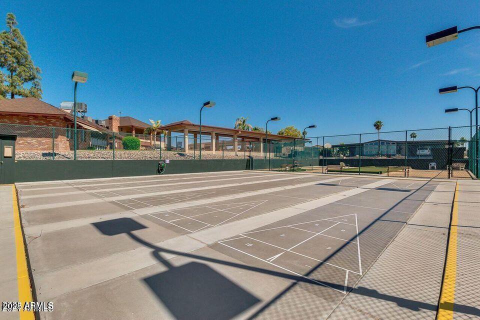 5735 East McDowell Road, Unit 63 Mesa, AZ 85215 - Photo 26 of 27 a view of a tennis ground with large trees