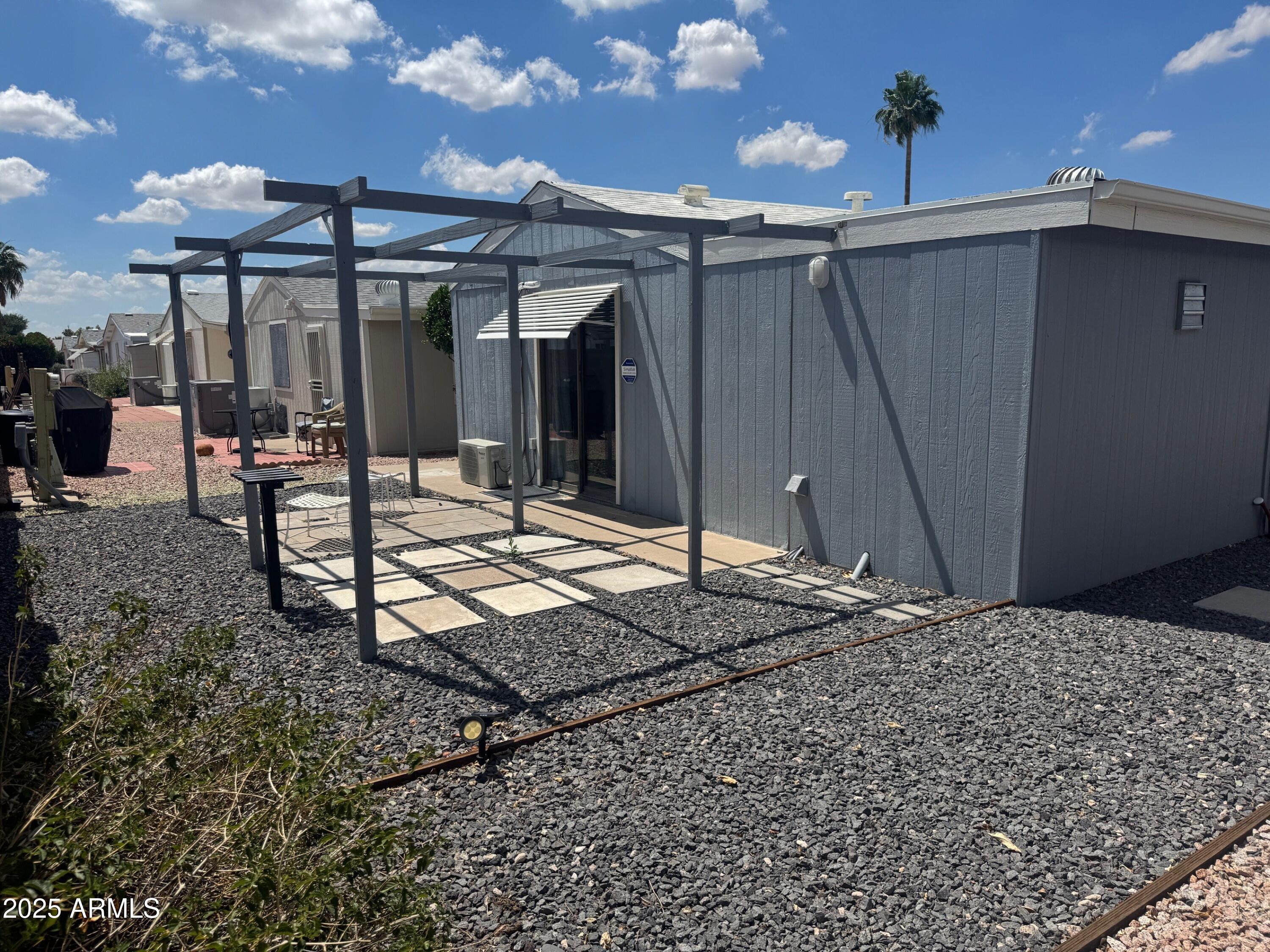 5735 East McDowell Road, Unit 63 Mesa, AZ 85215 - Photo 8 of 27 a wooden bench sitting in front of a building