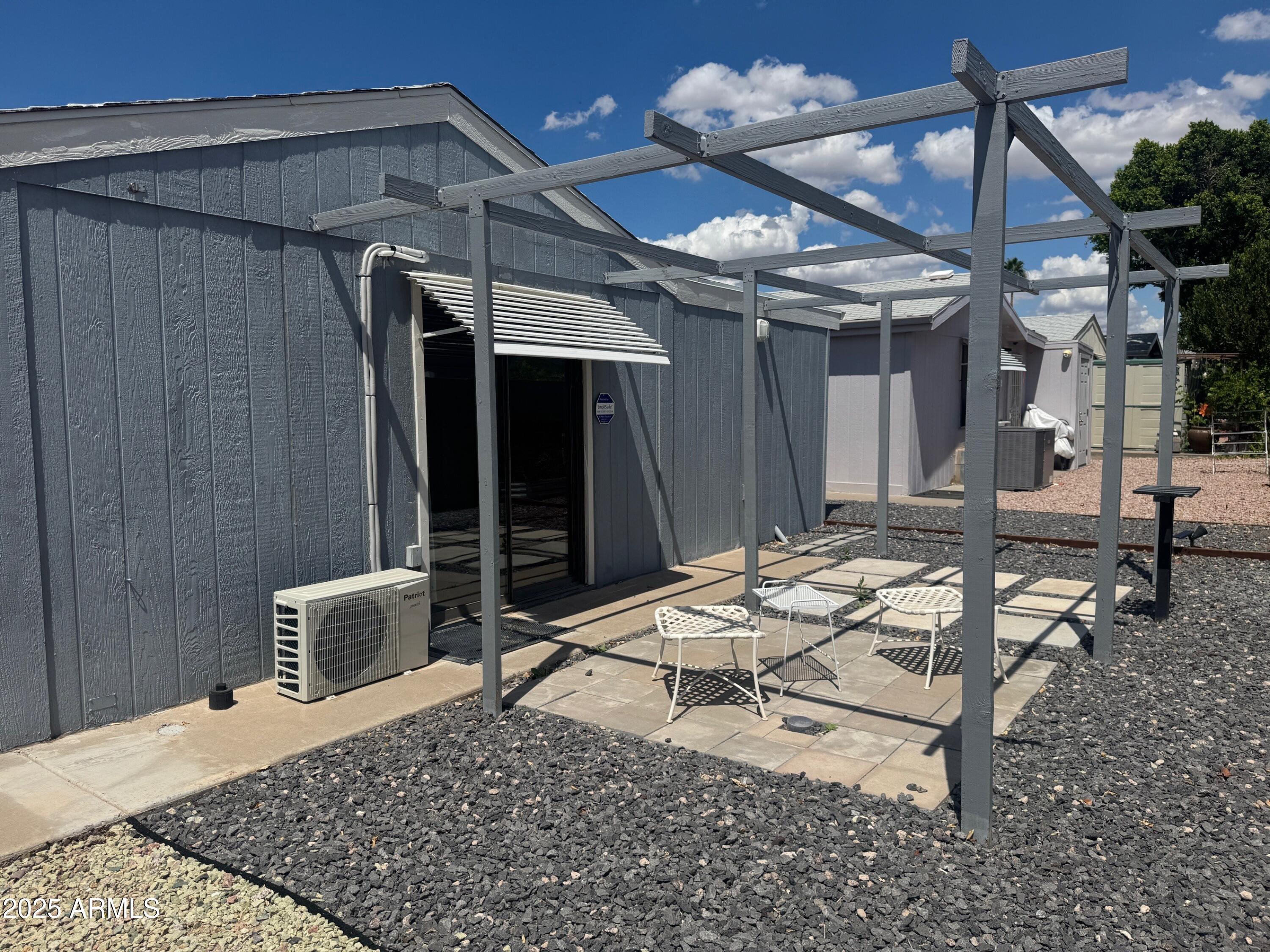 5735 East McDowell Road, Unit 63 Mesa, AZ 85215 - Photo 9 of 27 a wooden bench sitting in front of a building