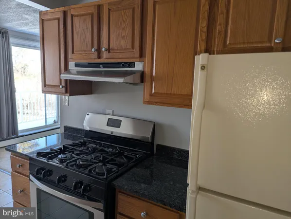 a kitchen with a stove and a cabinet