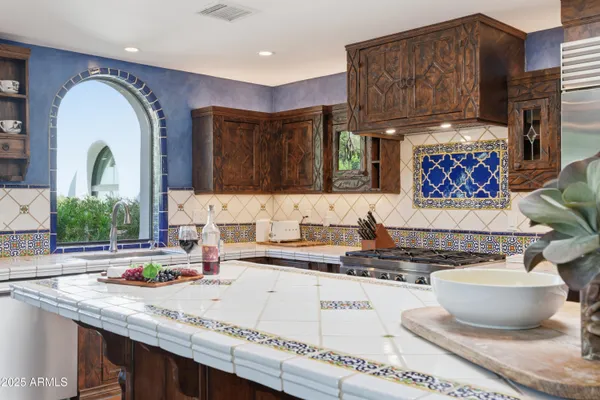 a kitchen with a stove a sink and a refrigerator