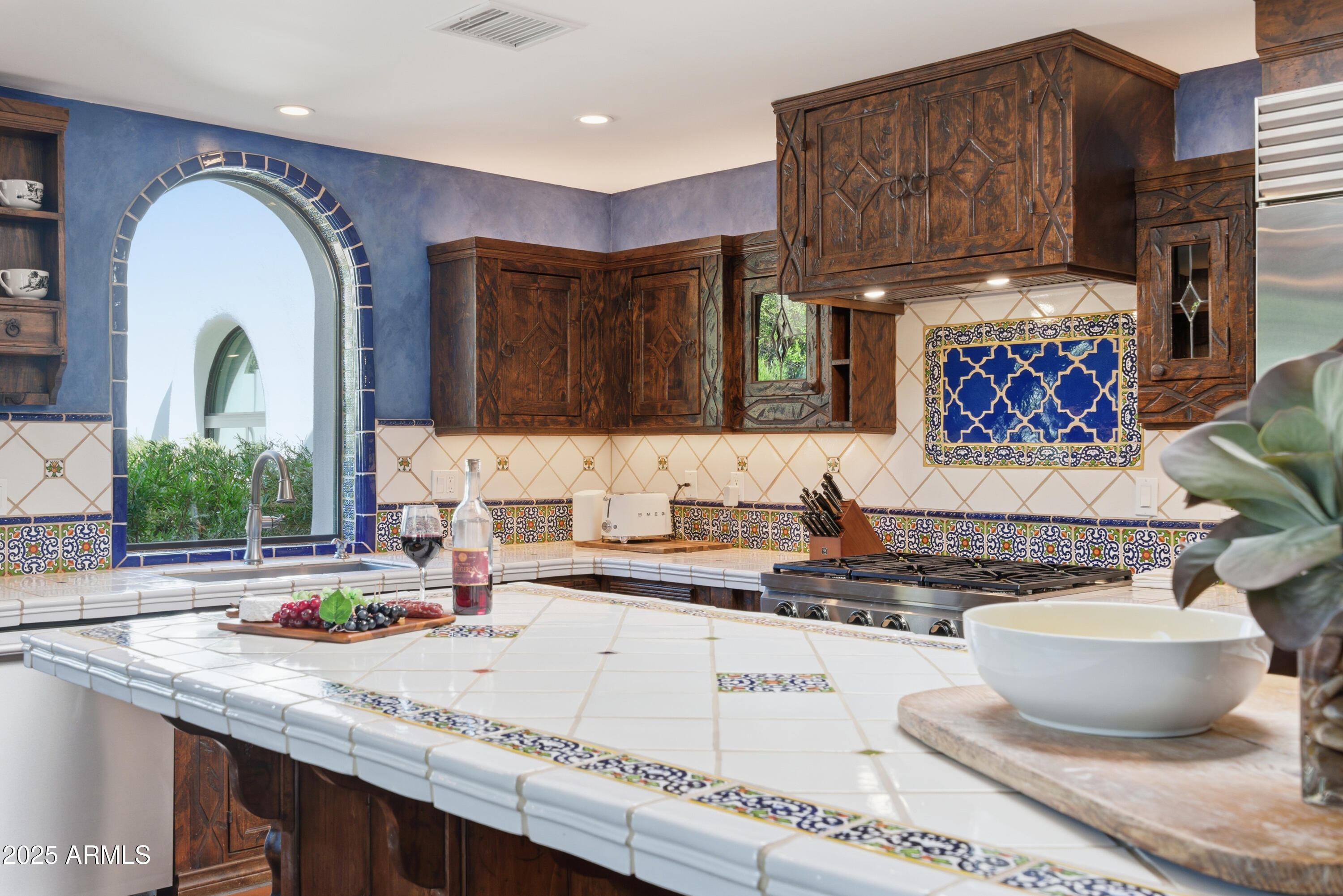 5828 East Cactus Wren Road Paradise Valley, AZ 85253 - Photo 11 of 44 a kitchen with a stove a sink and a refrigerator