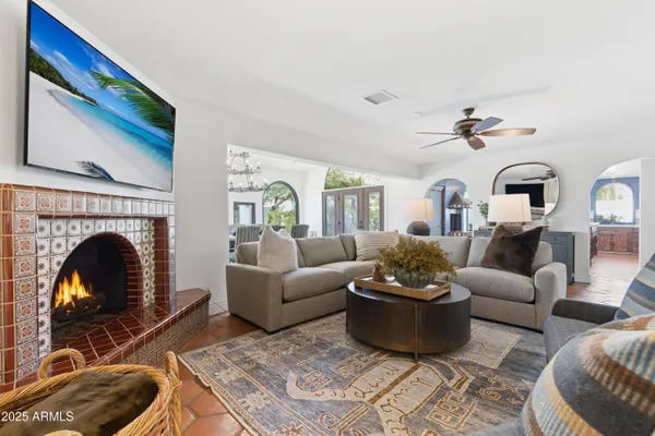 a living room with furniture a fireplace and a flat screen tv