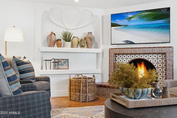 a living room with furniture and a fireplace