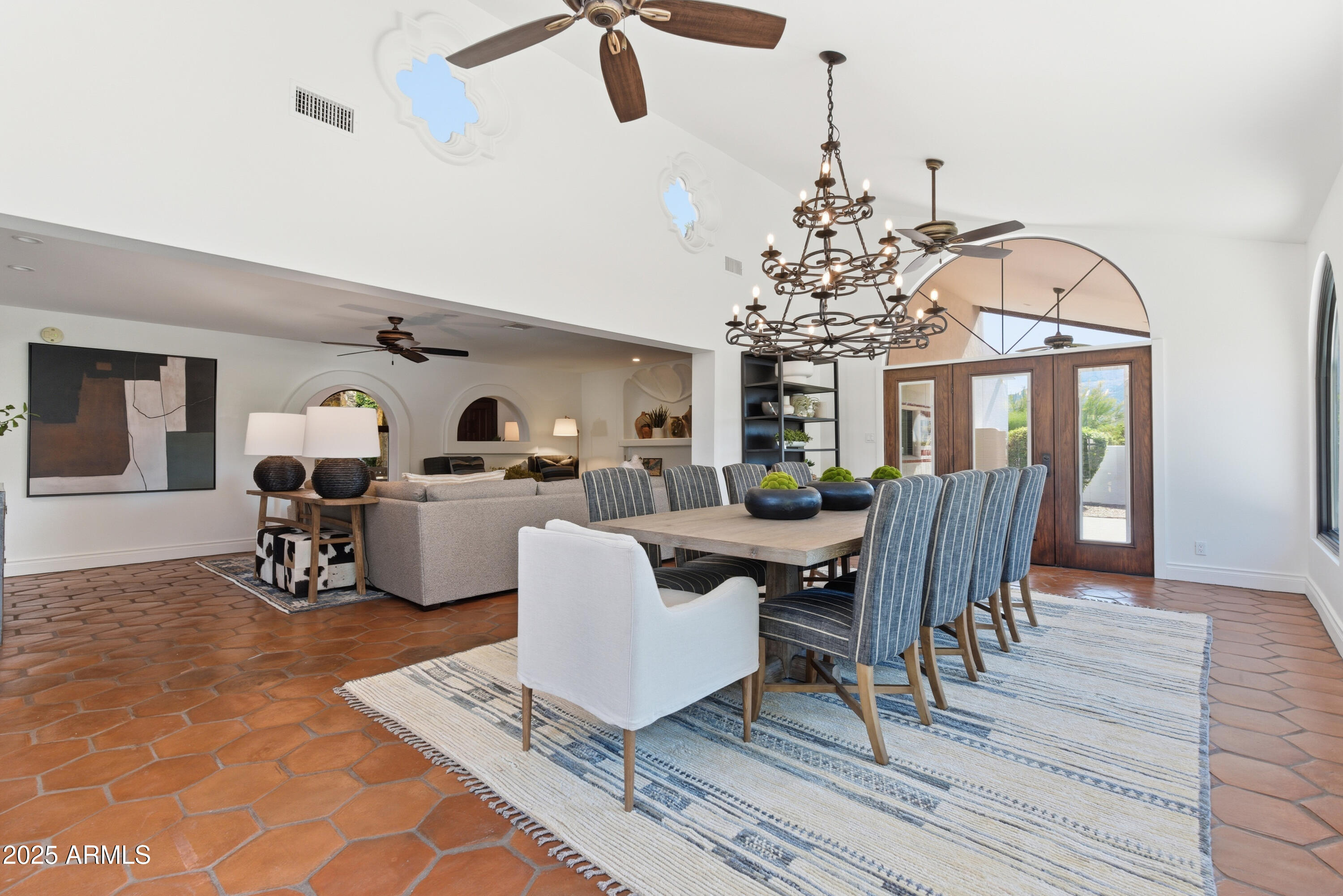 5828 East Cactus Wren Road Paradise Valley, AZ 85253 - Photo 17 of 44 a living room with furniture a dining table and a chandelier