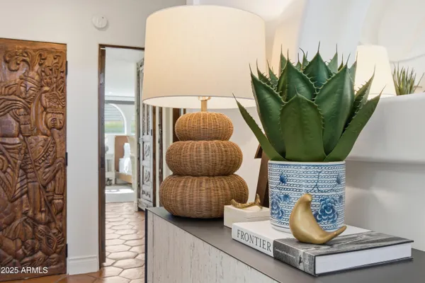 a living room with furniture and a potted plant