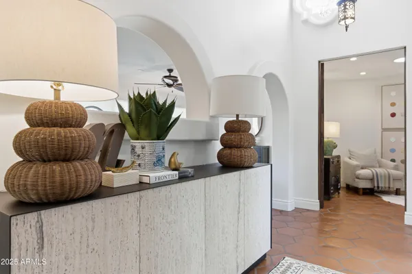 a living room with furniture and a potted plant