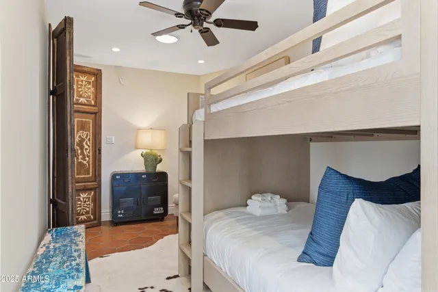 a bedroom with a bed and a chandelier