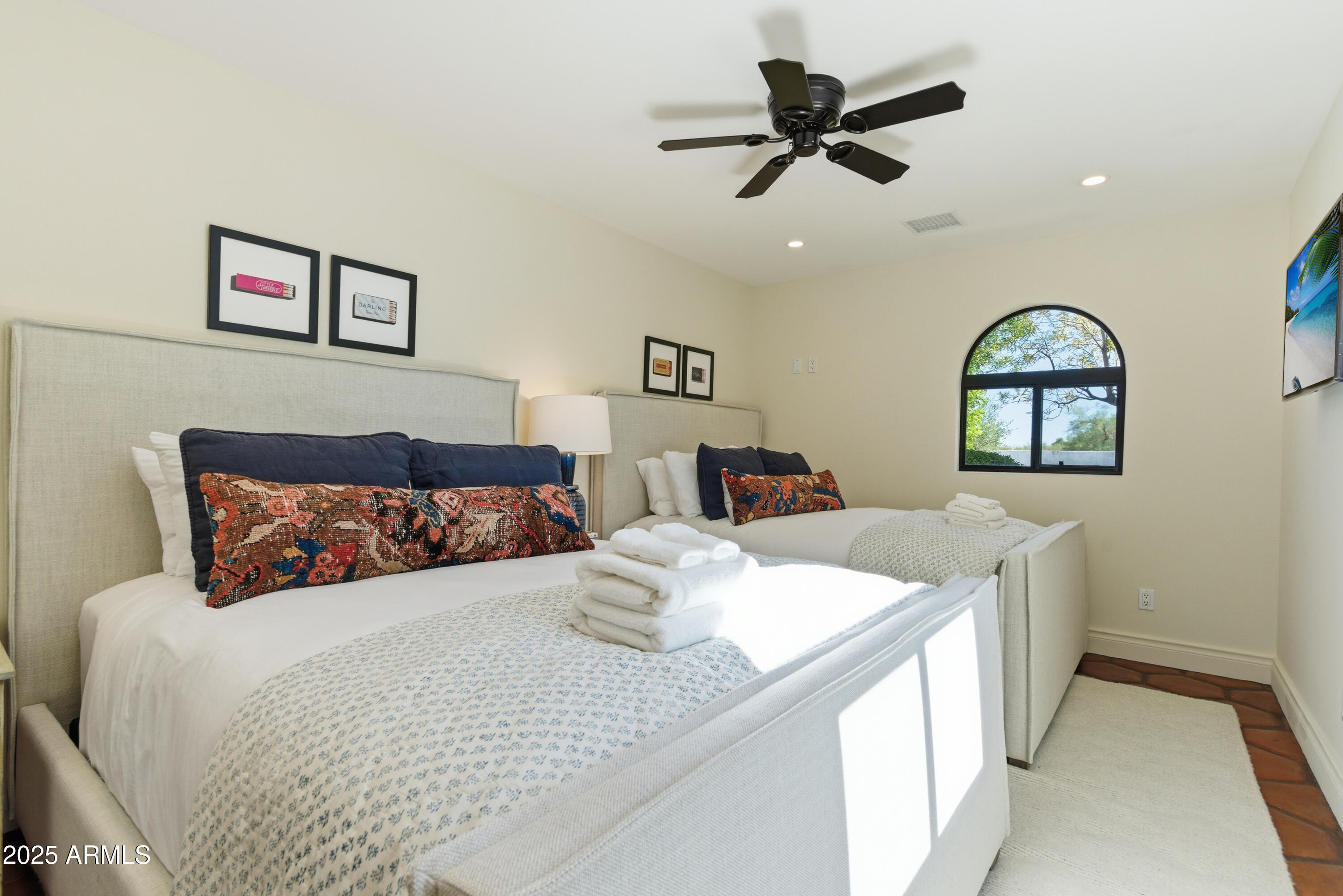 5828 East Cactus Wren Road Paradise Valley, AZ 85253 - Photo 25 of 44 a bedroom with a large bed and a chandelier