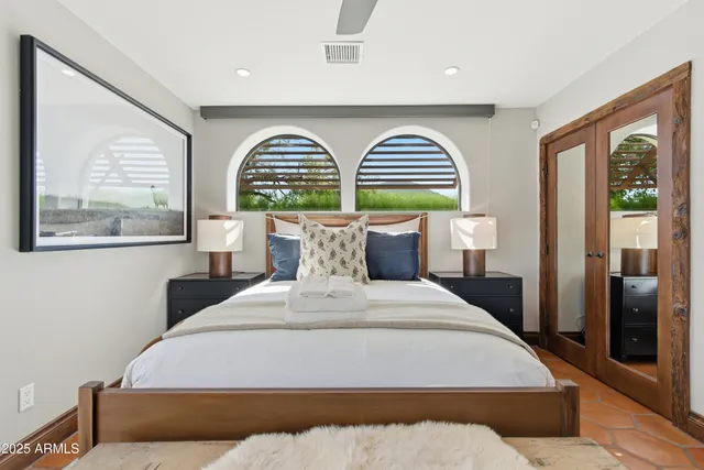 a bedroom with a large bed and a large window