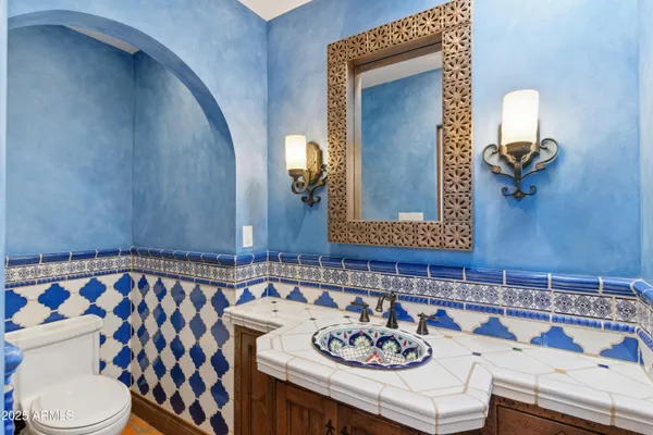 a bathroom with a sink a toilet and mirror