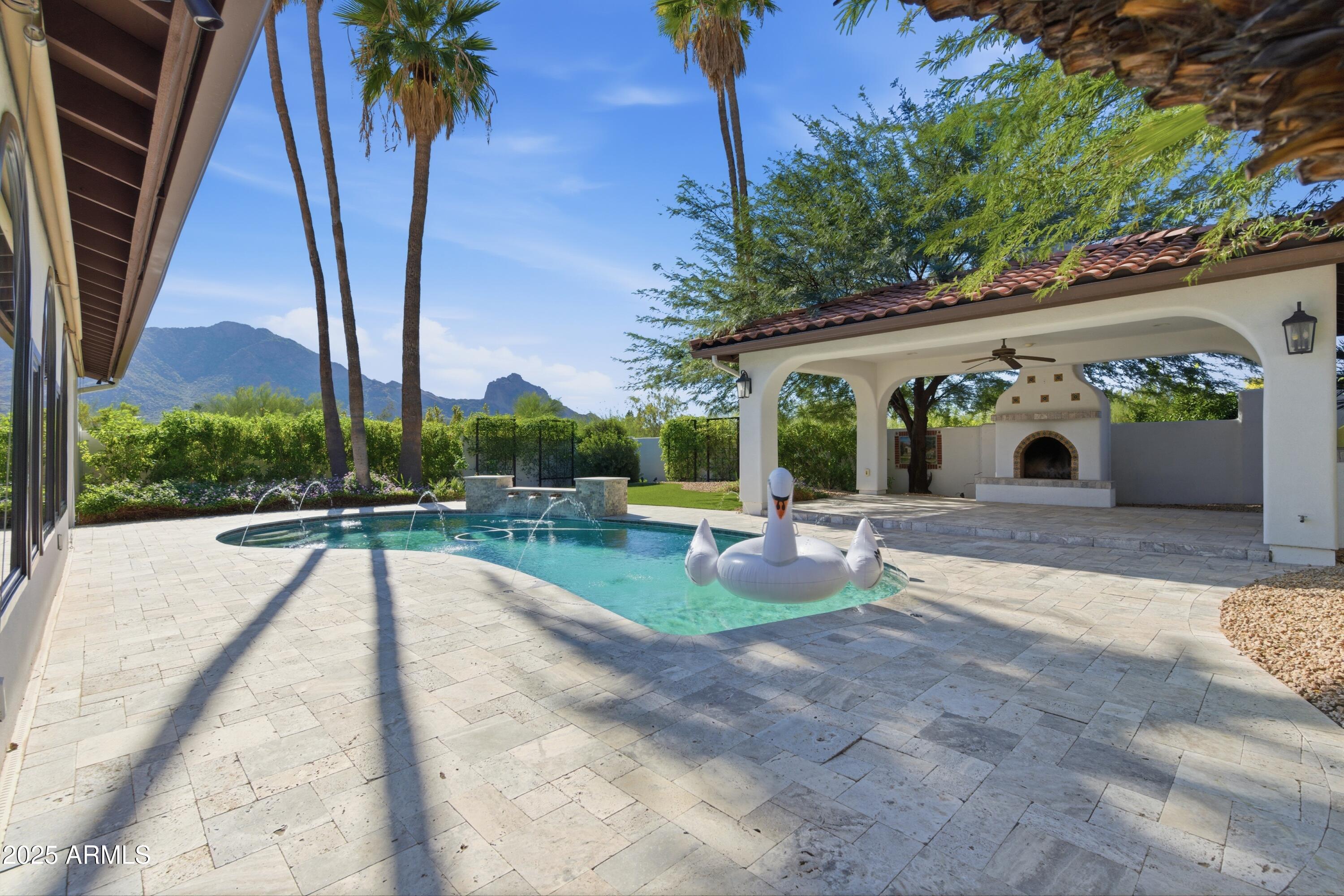 5828 East Cactus Wren Road Paradise Valley, AZ 85253 - Photo 3 of 44 a view of a swimming pool with a patio