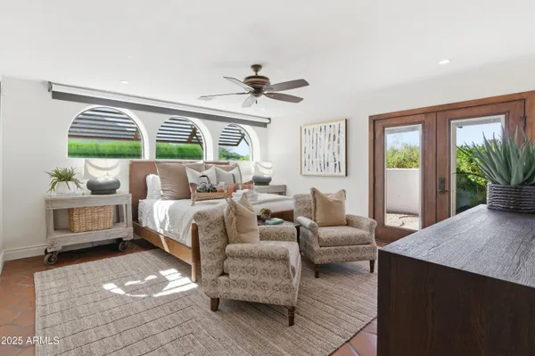 a bedroom with furniture and windows