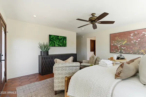 a bedroom with two beds and a potted plant