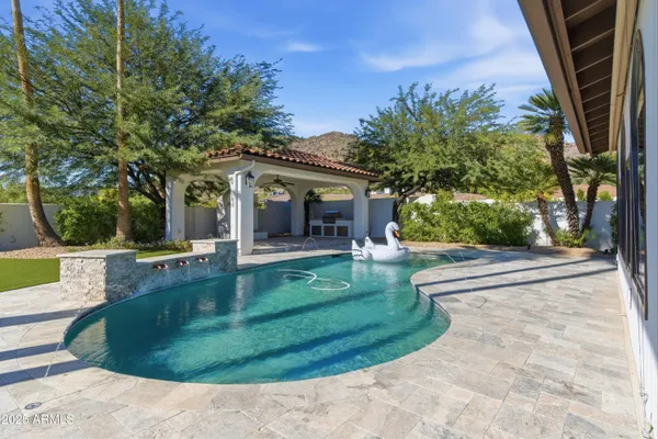 a view of a house with backyard and sitting area