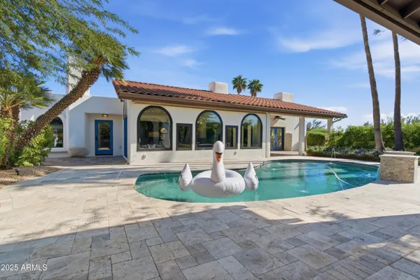 a front view of a house with a garden and plants