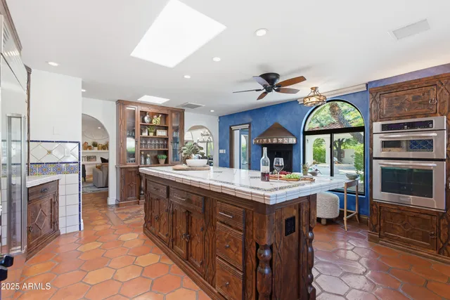 a open kitchen with stainless steel appliances a stove cabinets and living room view