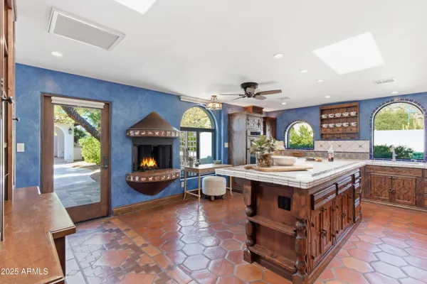 a kitchen with a stove and a fireplace