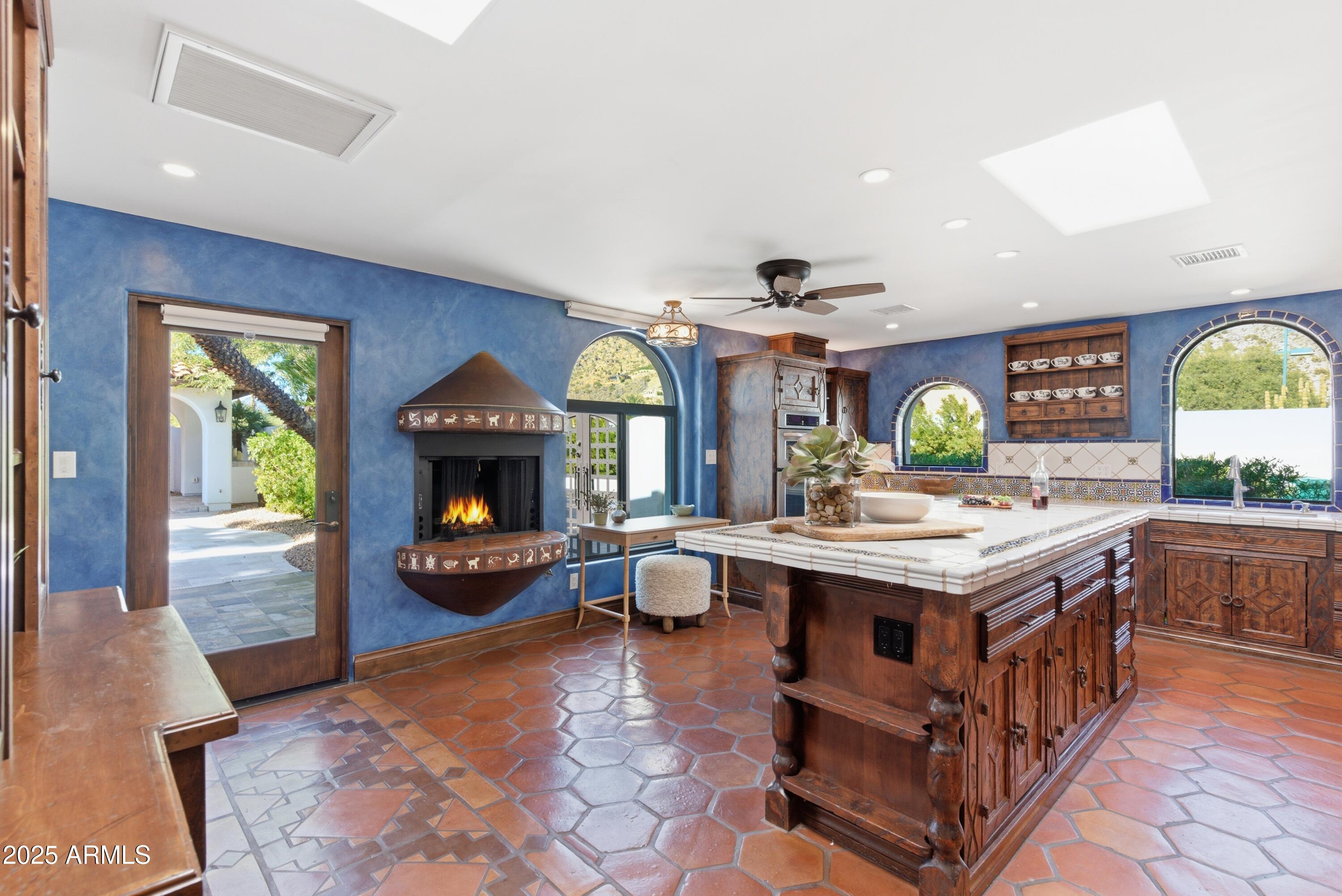 5828 East Cactus Wren Road Paradise Valley, AZ 85253 - Photo 6 of 44 a kitchen with a stove and a fireplace