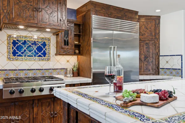 a kitchen with a stove and a refrigerator