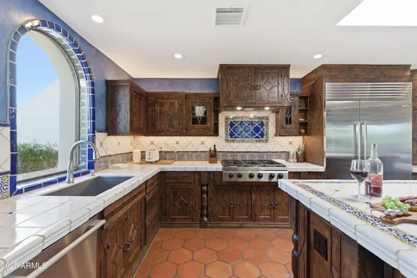a kitchen with stainless steel appliances granite countertop a sink stove and cabinets